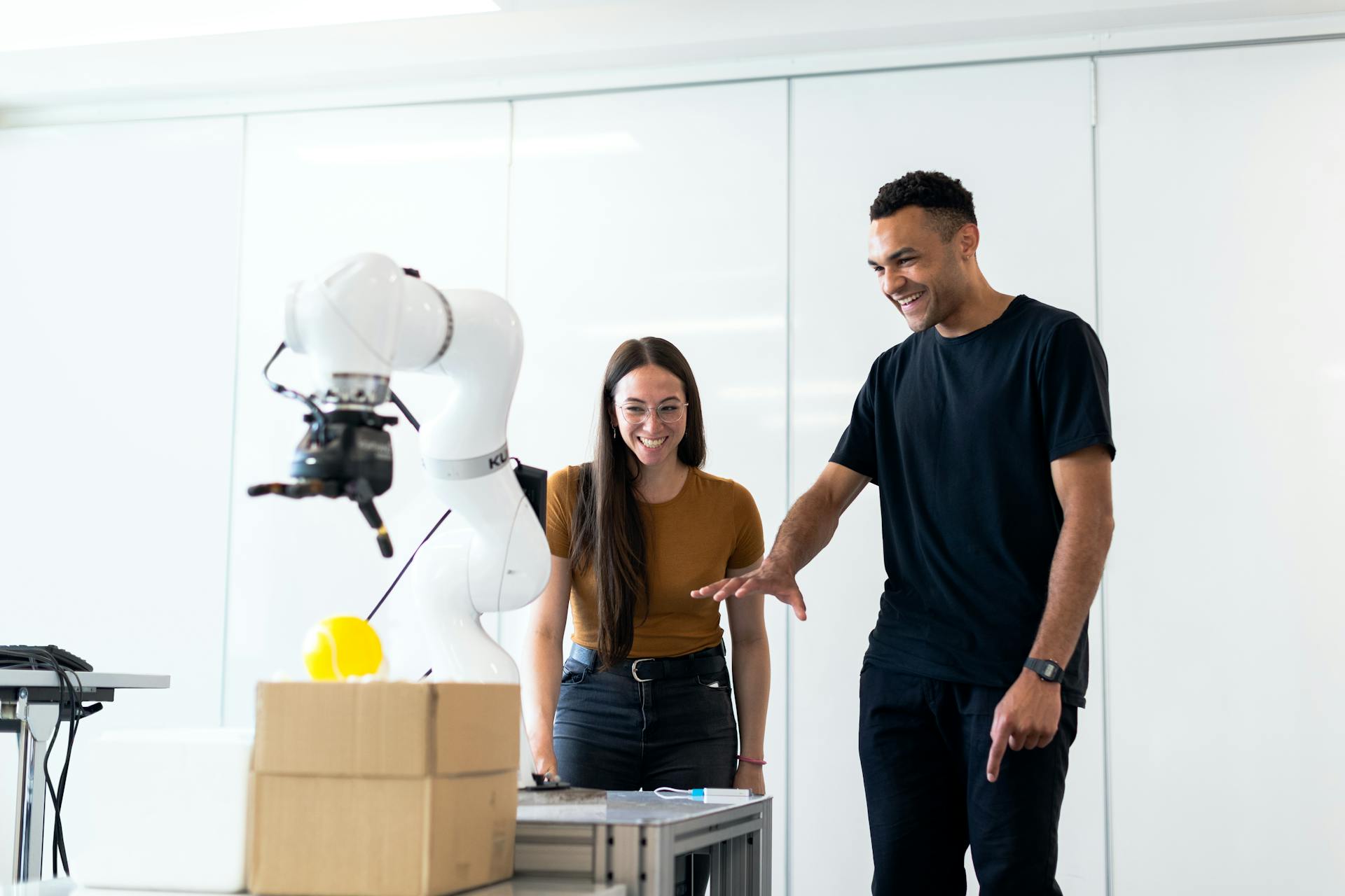 Engineers collaborating on robotic arm